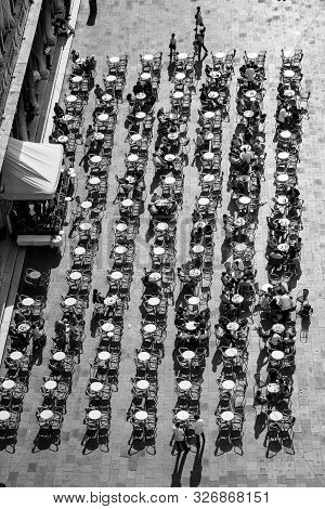 Venice, Italy - July 4, 2007: Tourists On San Marco Square Rest In An Alfresco Cafe At San Marco Squ