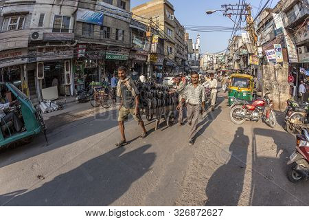 New Delhi, India - Nov 17, 2011: Man Carries  Heavy Cargo  With His Wooden Cart In Old Delhi, Chawri