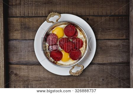 Turkish Sausage (sucuk) and egg isolated on rustic wooden table