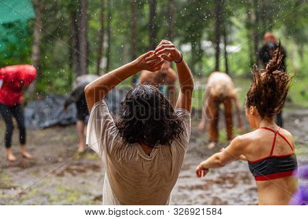A Large Group Of Men And Women Experience Mindful Dance And Meditation In A Muddy Woodland Clearing 