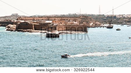 The View From The Fort At Valletta, Malta Looking Across The Ocean At Fort St Angelo.