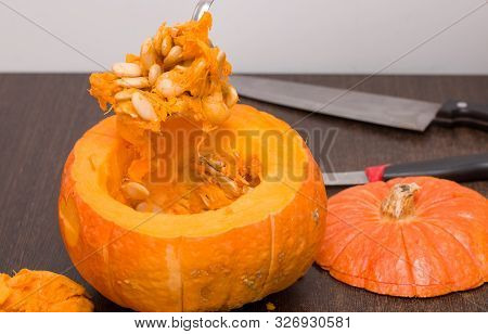 Very Tasty Pumpkin Spoon With Brush Of Pumpkin Two Knides On The Backgound Woode Brown Table Seeeds 