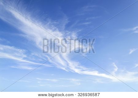 Translucent Airy Cirrus Clouds High In A Blue Sky. Cloud Species And Varieties. Atmospheric Phenomen
