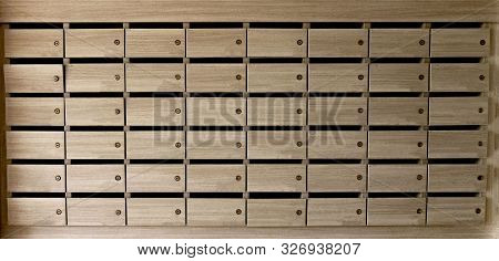 Closeup Of Unnumbered Mailboxes And Lockers In Raw In The Condo. Natural Wooden Letterbox Panel Patt