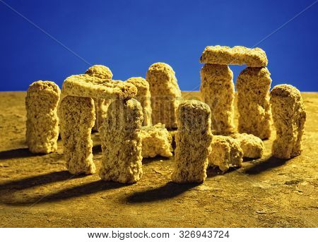 A Representation Of Stonehenge Made With Biscuit Rusks Laid Out On Top Of A Rusty Metal Sheet And A 