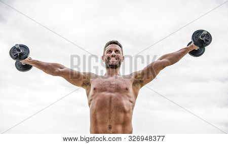 Power And Balance. Fitness And Sport Equipment. Muscular Man Exercising In Morning With Barbell. Ath