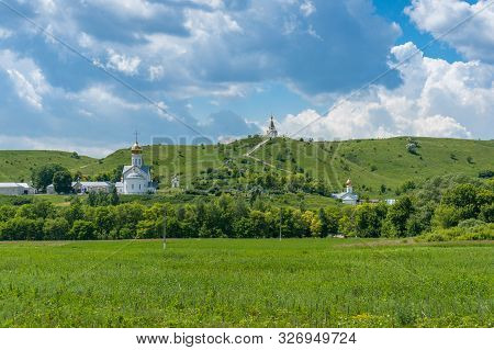 Monastery Complex With White Churches And Golden Cupola. Countryside Nature Landscape With Green Gra