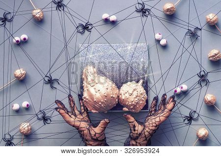 Hands In Mesh Gloves Tied Up In Spiders Web. Creapy Halloween Background In Grey, Black And Pink Wit