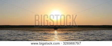 Sunset In The Delta Of The Volga River On The River Baklanya. The Astrakhan Region. Russia. Blurred 