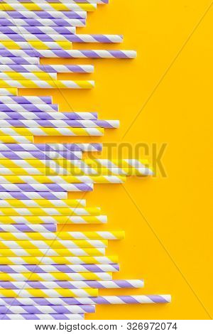 Row Of Elegant White Striped Paper Drinking Straws On Yellow Background. Birthday Party Babyshower I