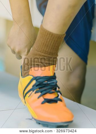 Close Up To Hand Of Young Man Wear Studded Before Play Soccer.