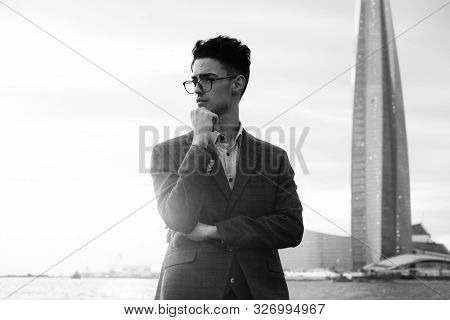 Elegant young handsome man. Symmer day. Black and white picture.