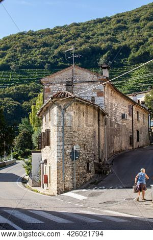 Santo Stefano, Italy - Sept 5, 2019:  Santo Stefano- Small Old Town And Hill With Vineyards Of The P