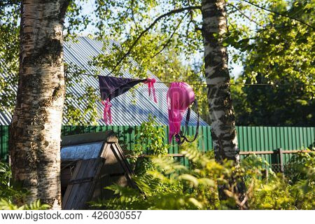 A Woman's Swimsuit Dries On A Rope. Summer Nature