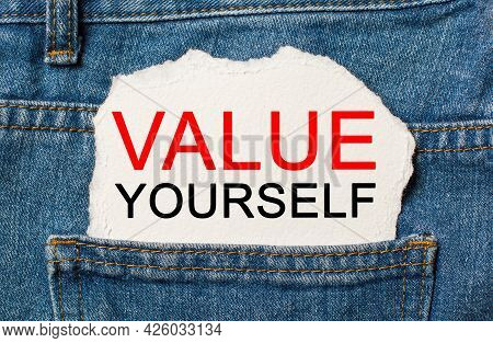 Value Yourself On Torn Paper Background On Jeans Business And Finance Concept