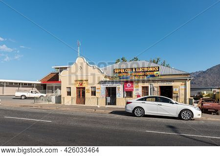 De Doorns, South Africa - April 20, 2021: A Street Scene, With Businesses And Vehicles, In De Doorns