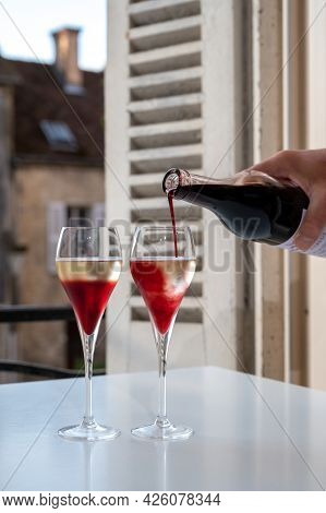 Drinking Of Kir Royal,  French Aperitif Cocktail Made  From Creme De Cassis Topped With Champagne, T