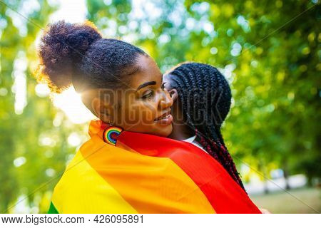 Brazilian Lesbian Couple In White Dress Spending Time Together Celebrating Engagement In Summer Park