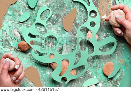 Abstract Natural Background, Wild Flowers And Natural Stones In Hands. Abstract Organic Shapes Cut O