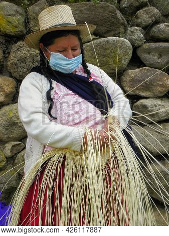Sigsig, Azuay, Ecuador - June 20, 2021: Indigenous Woman Demonstrates Tradition Weaving Of Panama Ha