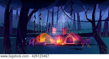 Night Camping With Tents, Campfire And Tourist Stuff In Dark Forest. Cozy Traveler Halt With Chair, 