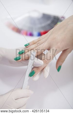 Vertical Close Up Of Manicurist Removing Nail Gel With Filer