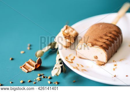 Chocolate Popsicles Cut With Filling Lying On White Plate On Cian Background