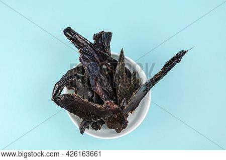 Training Treats For Pets On Blue Background. Natural Air Dried Dog Treats In A White Ceramic Bowl. T
