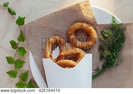 Close-up Of Onion Rings In Batter. Fried Vegetables At A Fast Food Restaurant. Vegetarian Cuisine In