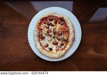 A Close-up Of A Mini Pizza In A Disposable Dish. Top View Of Takeaway Food In Fast Food Cafe. The Ph