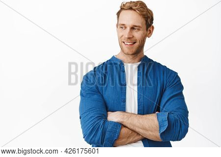 Close Up Of Handsome Confident Guy With Red Hair And Bristle, Cross Strong Arms Over Chest, Smiling 