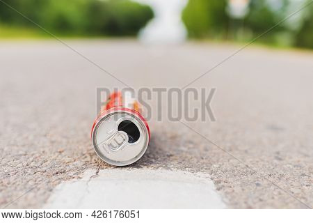 Aluminum Can Is Flat Lay,lying On The Road. Can Fall On The Street, It Can Be Recycled.summer Day Bl