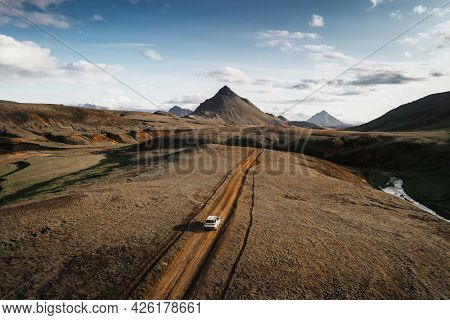 2019, Iceland, White Landrover driving on a dusty sand road