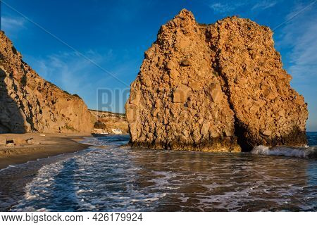 Fyriplaka beach and waves of Aegean sea on sunset, Milos island, Cyclades, Greece