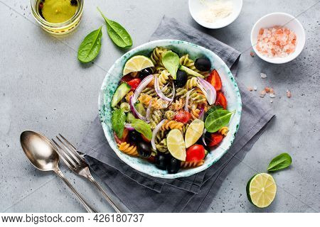 Whole Grain Pasta With Vegetables On A White Plate On A Light Grey Slate, Stone Or Concrete Backgrou