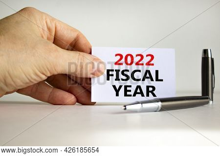 2022 Fiscal New Year Symbol. White Paper With Words '2022 Fiscal Year' In Businessman Hand, Metallic
