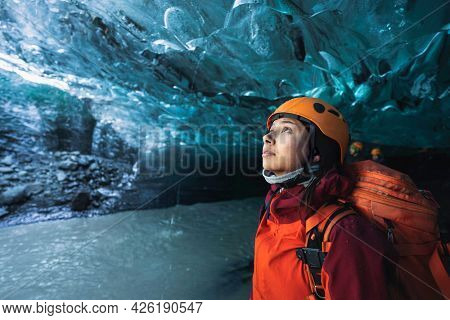 Female explorer in the ice cave, Iceland