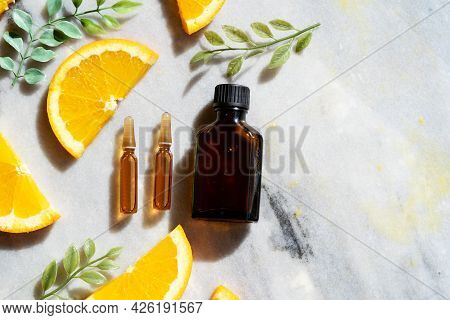 Citrus Fruit Vitamin C Serum Oil Beauty Care Bottle And Ampulas Top View, Anti Aging Natural Cosmeti