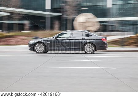 Moscow , Russia - May 2021: Black Bmw 5 F10 In Motion. Bmw 5 Series At High Speed With Blurred Backg