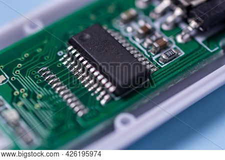 Close-up Microchip Uncover Usb Stick With A Board On A Blue Background