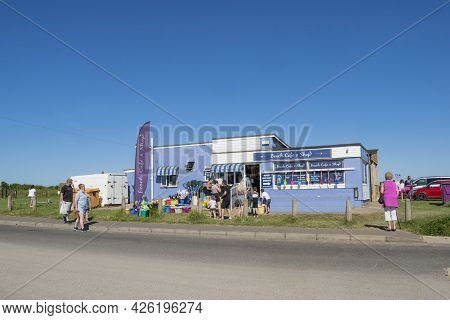 Old Hunstanton, Norfolk, England - June 13 2021. Old Hunstanton Beach Cafe And Shop With People At T
