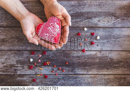 Valentine Day Gingerbread Cookies Heart In Wooman Hands With Sprinkles On Wooden Background