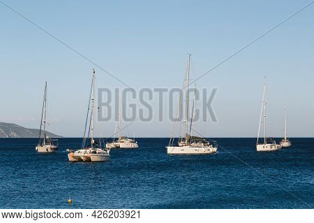 White Yachts Anchored In A Blue Bay Of Agia Efimia Port, Cephalonia Island, Greece
