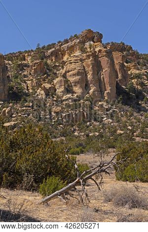 Sandstone Bluffs Rising Above The Arid Valley In El Malpais National Monument In New Mexico
