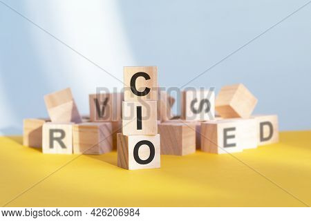 Cio Written On Wooden Cubes - Arranged In A Vertical Pyramid, Grey And Yellow Background, Cio - Shor