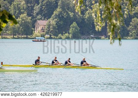 Bled, Slovenia - June 13, 2021: Four Young Male Adults, Rowers, On A Coxed Four, A Rowing Boat, Trai