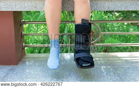 Boot Support On Womon's Leg To Support Her Injured Ankle From Accident