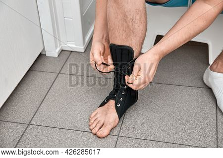 The Male Leg Is Fixed In A Medical Bandage. Ankle Fracture Or Sprain. Lacing And Tight Fit Of The Fo