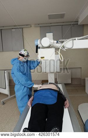The Work Of A Radiologist In Antiviral Overalls In The X-ray Room For Diagnostics.