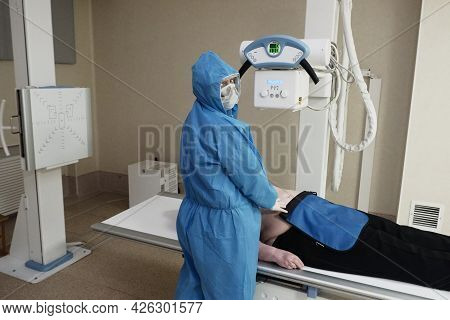 The Work Of A Radiologist In Antiviral Overalls In The X-ray Room For Diagnostics.